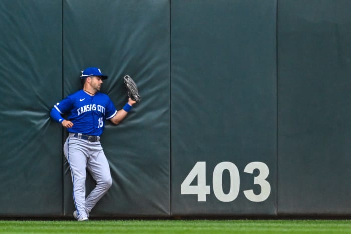May 28, 2022; Minneapolis, Minnesota, USA; Kansas City Royals right fielder Whit Merrifield (15) crashes into the wall after making a leaping catch against the Minnesota Twins during the first inning at Target Field. Mandatory Credit: Nick Wosika-USA TODAY Sports